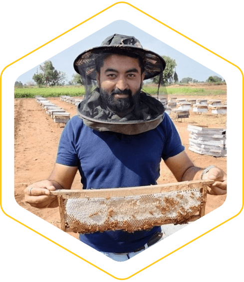 Abhishek Joshi, founder of VitaBee, holding a honeycomb frame